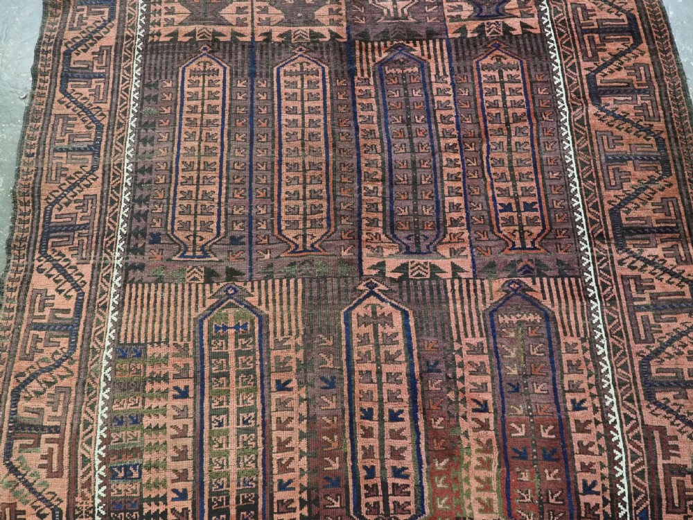An antique hand-knotted wool carpet featuring a repeating kalam donneh pencil box pattern in shades of terracotta, dark brown, and indigo blue. View V