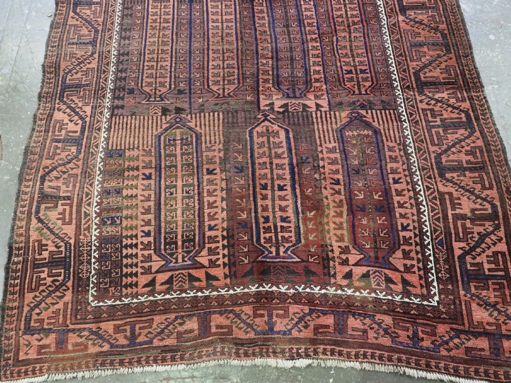 An antique hand-knotted wool carpet featuring a repeating kalam donneh pencil box pattern in shades of terracotta, dark brown, and indigo blue. View VI