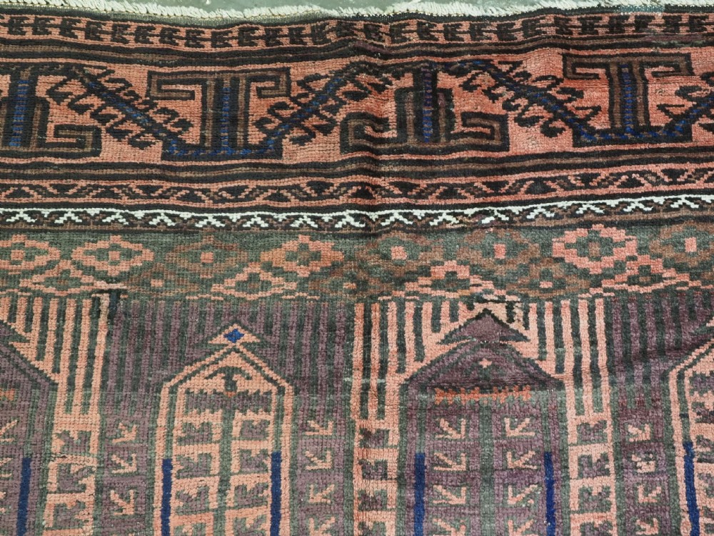 An antique hand-knotted wool carpet featuring a repeating kalam donneh pencil box pattern in shades of terracotta, dark brown, and indigo blue. View IX