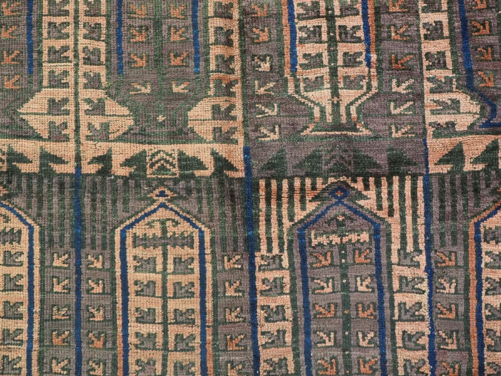 An antique hand-knotted wool carpet featuring a repeating kalam donneh pencil box pattern in shades of terracotta, dark brown, and indigo blue. View XI