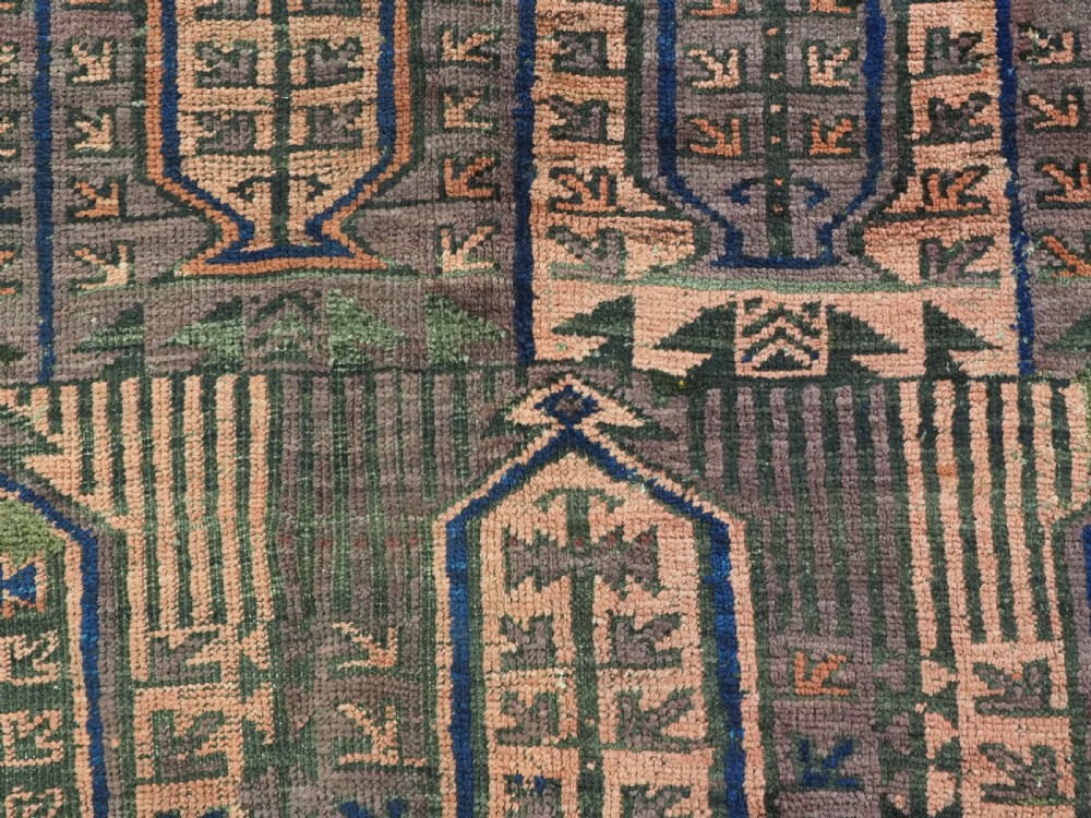 An antique hand-knotted wool carpet featuring a repeating kalam donneh pencil box pattern in shades of terracotta, dark brown, and indigo blue. View XII
