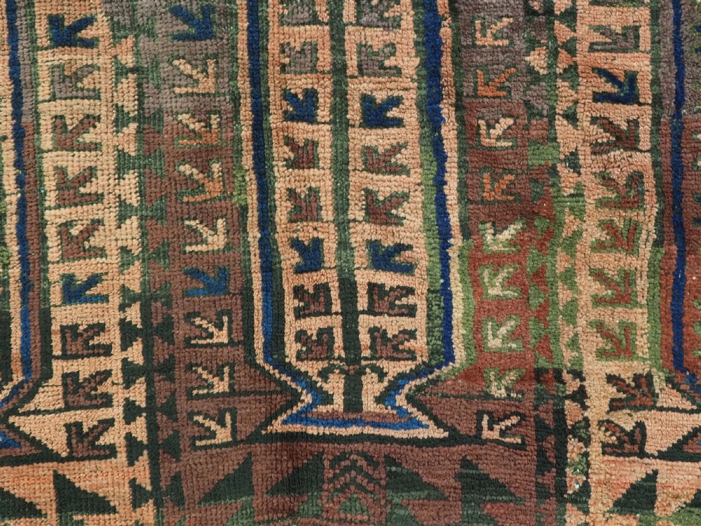 An antique hand-knotted wool carpet featuring a repeating kalam donneh pencil box pattern in shades of terracotta, dark brown, and indigo blue. View XIII
