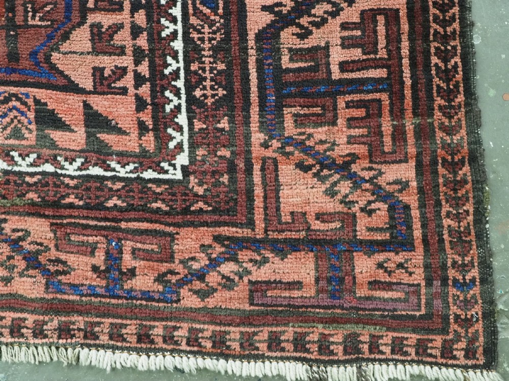 An antique hand-knotted wool carpet featuring a repeating kalam donneh pencil box pattern in shades of terracotta, dark brown, and indigo blue. View XV