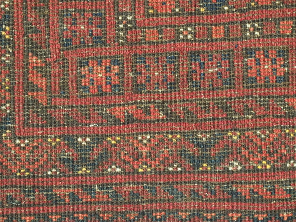 A large hand-knotted red wool carpet featuring repeated octagonal gul motifs across the central field with geometric borders. View XIX