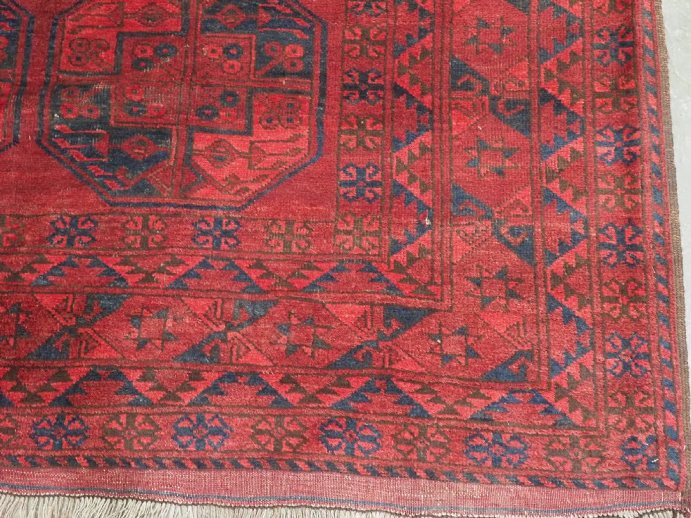 A large antique hand-knotted Afghan Ersari wool carpet featuring repeating octagonal gul patterns on a deep red field. View XI