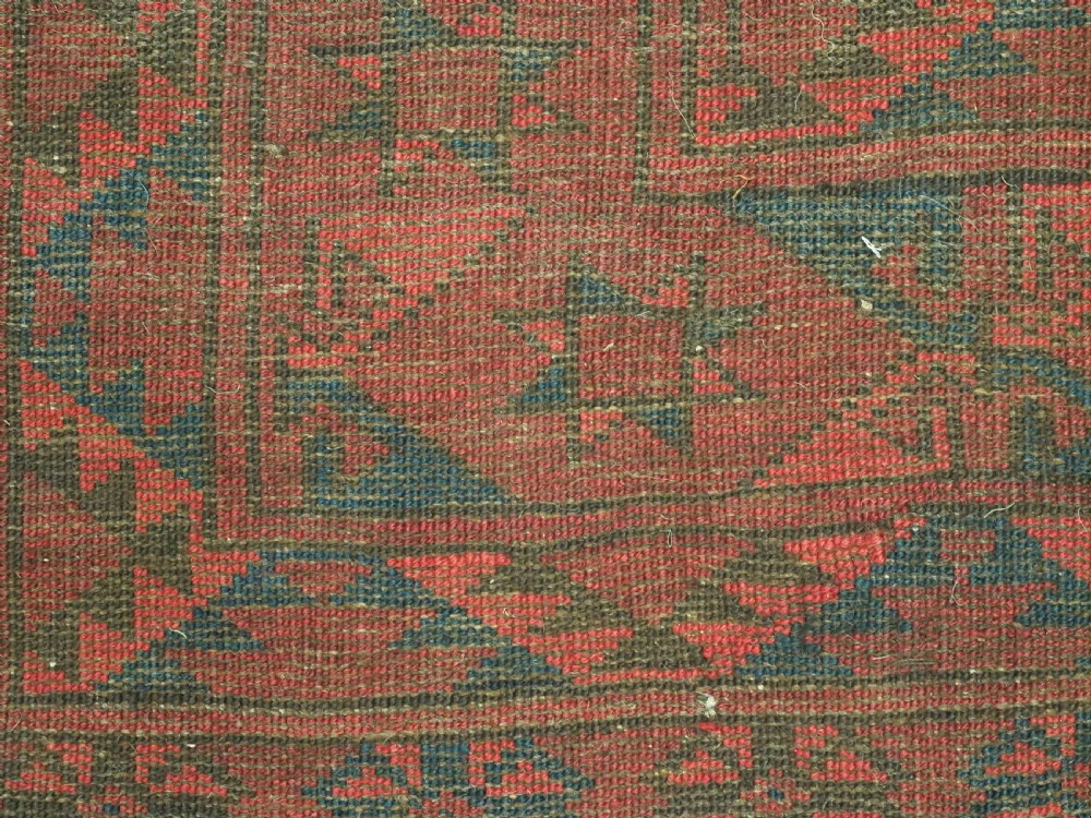A large antique hand-knotted Afghan Ersari wool carpet featuring repeating octagonal gul patterns on a deep red field. View XII