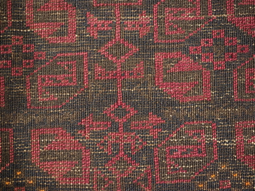 An antique hand-woven Baluch saddle bag face featuring dark red and navy geometric tile patterns with flatwoven web borders. View VII