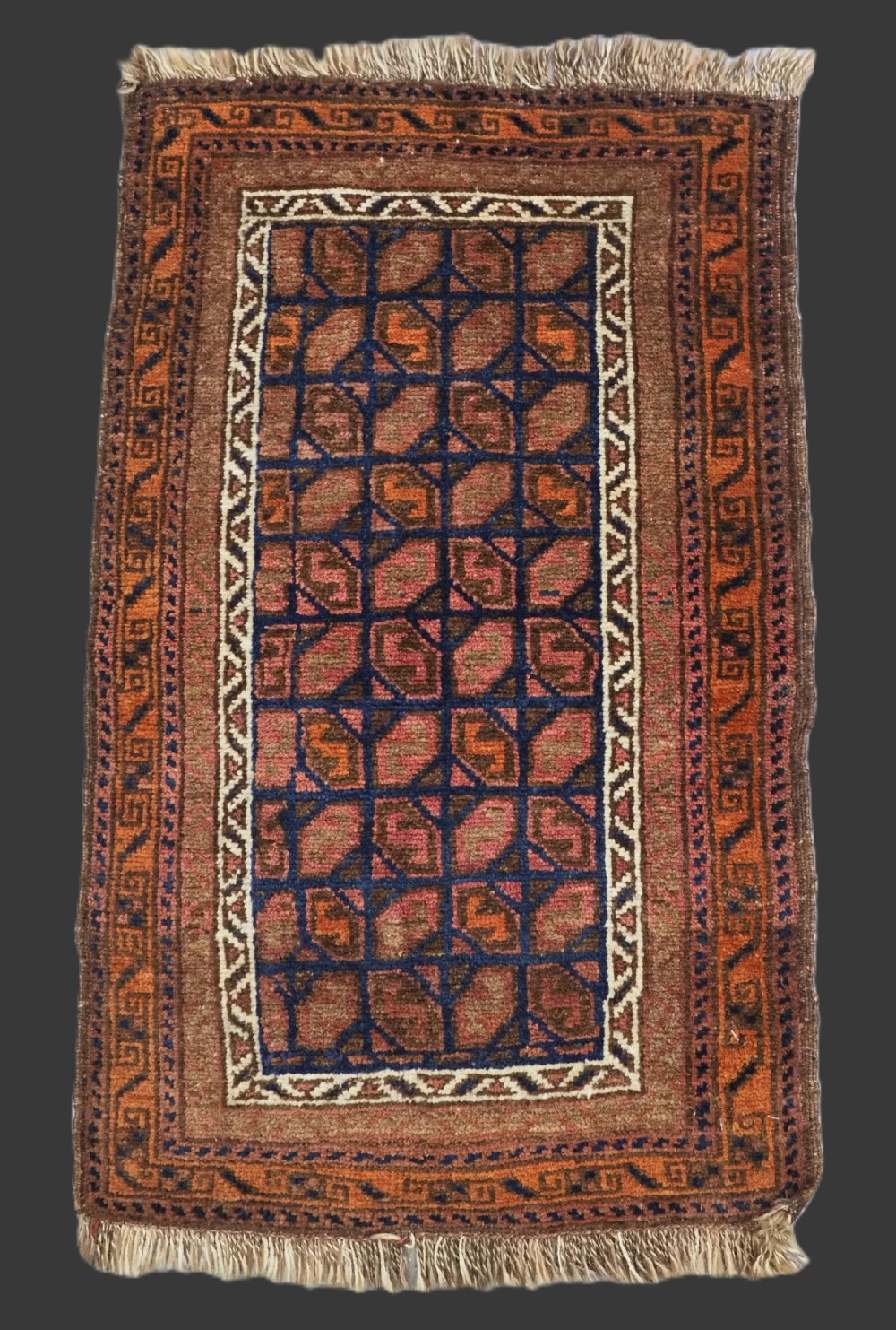 ANTIQUE AFGHAN BALUCH PUSHTI FACE WITH 'TILE' DESIGN, CIRCA 1900.