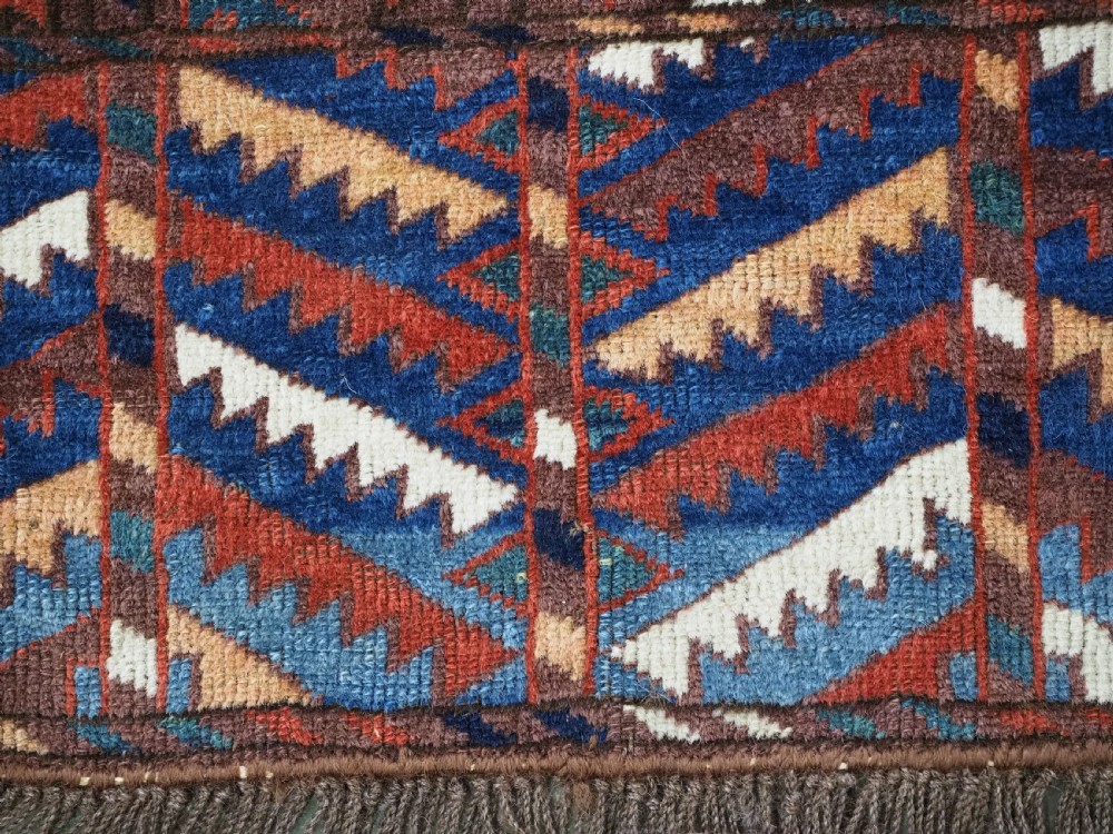 An antique late nineteenth-century Yomut Turkmen Ensi wool rug featuring a cruciform hatchli design in deep red-brown, navy blue, and ivory tones with a double tree elem skirt. View XIV