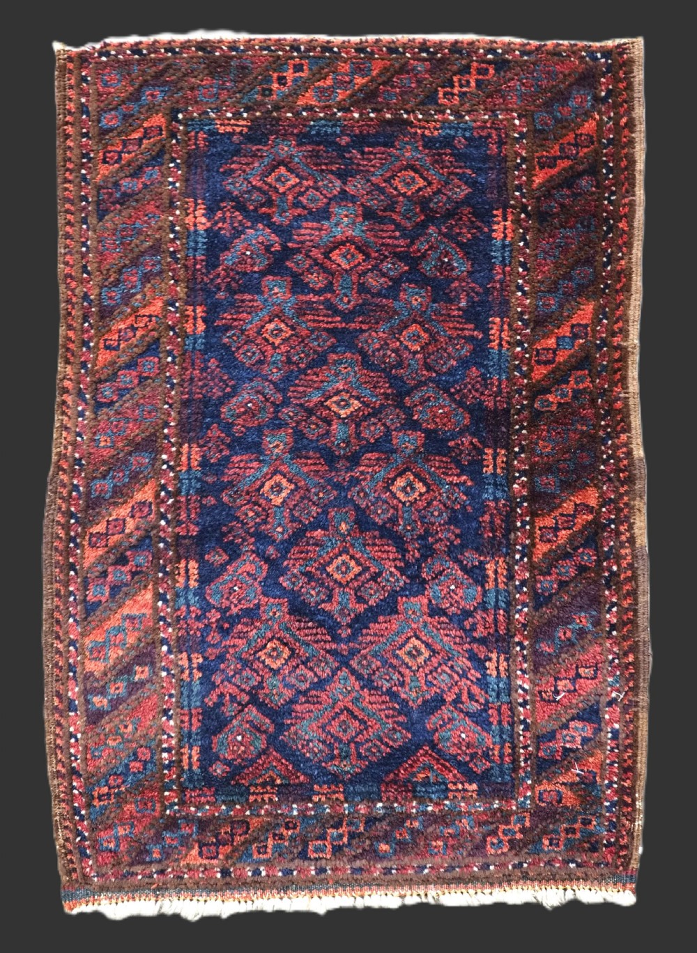 ANTIQUE SISTAN BALUCH PUSHTI FACE WITH TRADITIONAL DESIGN, CIRCA 1900.