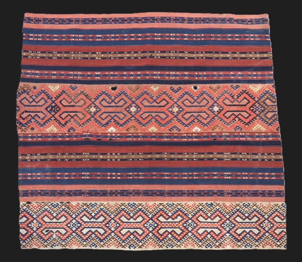 An antique handwoven Uzbek kilim panel constructed from four joined strips featuring terracotta red, indigo blue, and ivory geometric patterns.