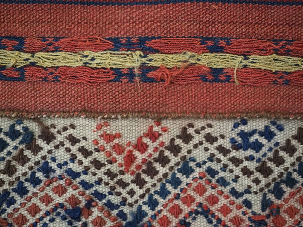 An antique handwoven Uzbek kilim panel constructed from four joined strips featuring terracotta red, indigo blue, and ivory geometric patterns. View XI