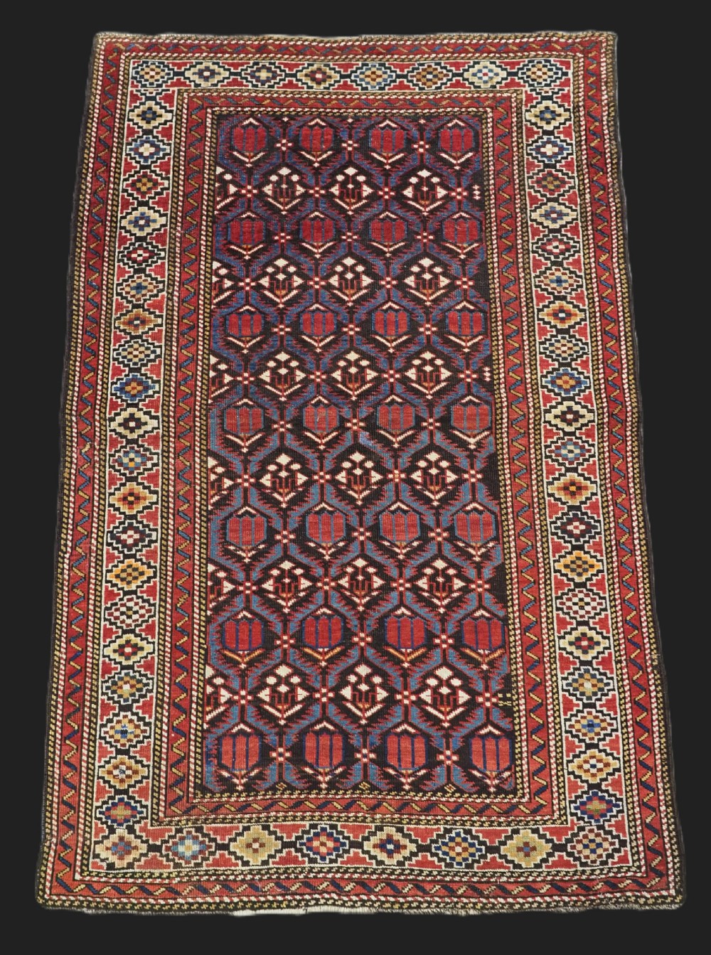 ANTIQUE CAUCASIAN SHIRVAN BAKU REGION RUG WITH 'TULIPS IN LATTICE' DESIGN, CIRCA 1890. 