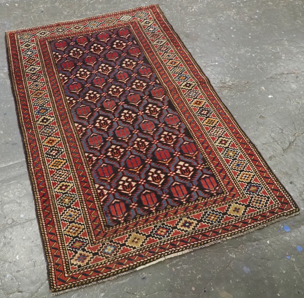 ANTIQUE CAUCASIAN SHIRVAN BAKU REGION RUG WITH 'TULIPS IN LATTICE' DESIGN, CIRCA 1890.  View II