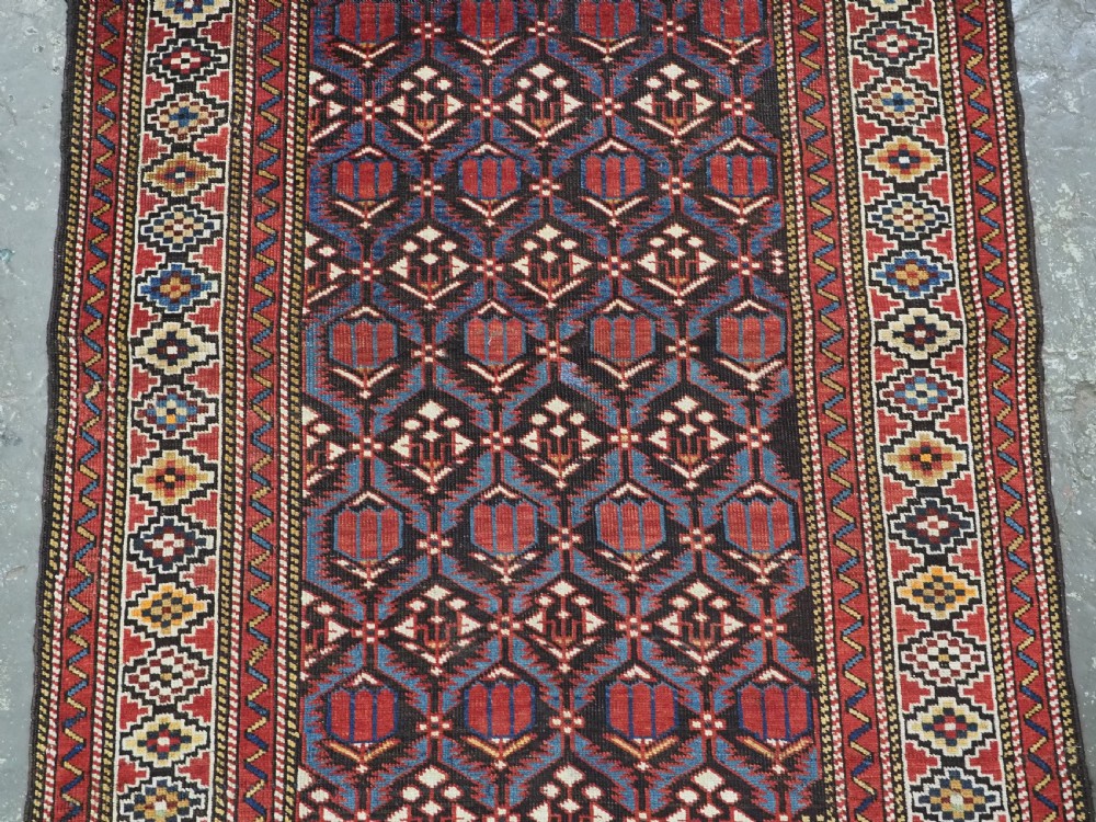 ANTIQUE CAUCASIAN SHIRVAN BAKU REGION RUG WITH 'TULIPS IN LATTICE' DESIGN, CIRCA 1890.  View IV
