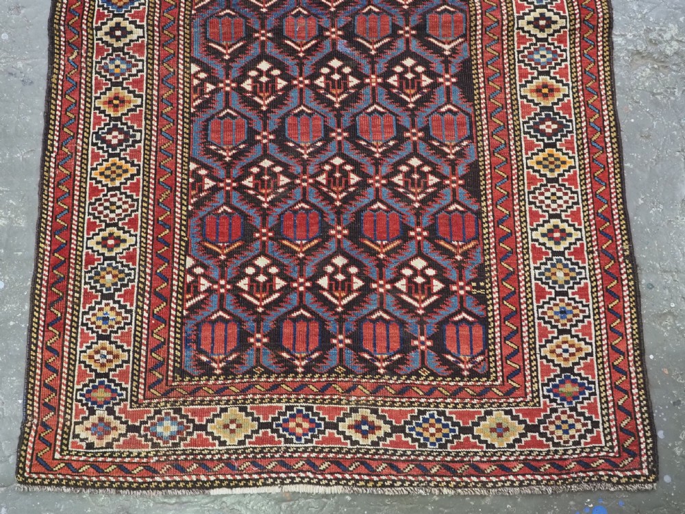 ANTIQUE CAUCASIAN SHIRVAN BAKU REGION RUG WITH 'TULIPS IN LATTICE' DESIGN, CIRCA 1890.  View V