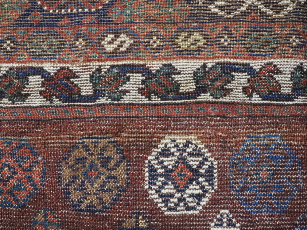 A late 19th-century South Persian hand-woven wool double saddle bag featuring geometric medallions, repeated guls, and stepped diamond patterns in shades of deep red, indigo blue, and ivory. View XV