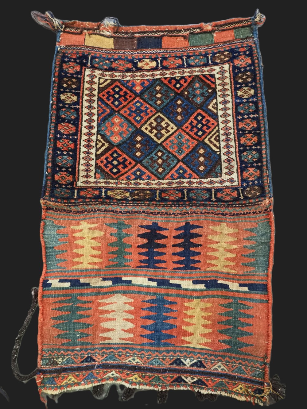 An antique 19th-century Jaf Kurd woven bag featuring a knotted pile upper panel with geometric diamond lattice motifs and a colourful flatweave back section.