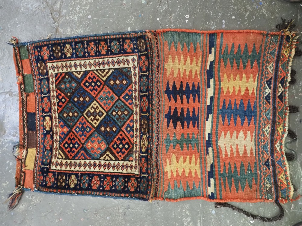 An antique 19th-century Jaf Kurd woven bag featuring a knotted pile upper panel with geometric diamond lattice motifs and a colourful flatweave back section. View II