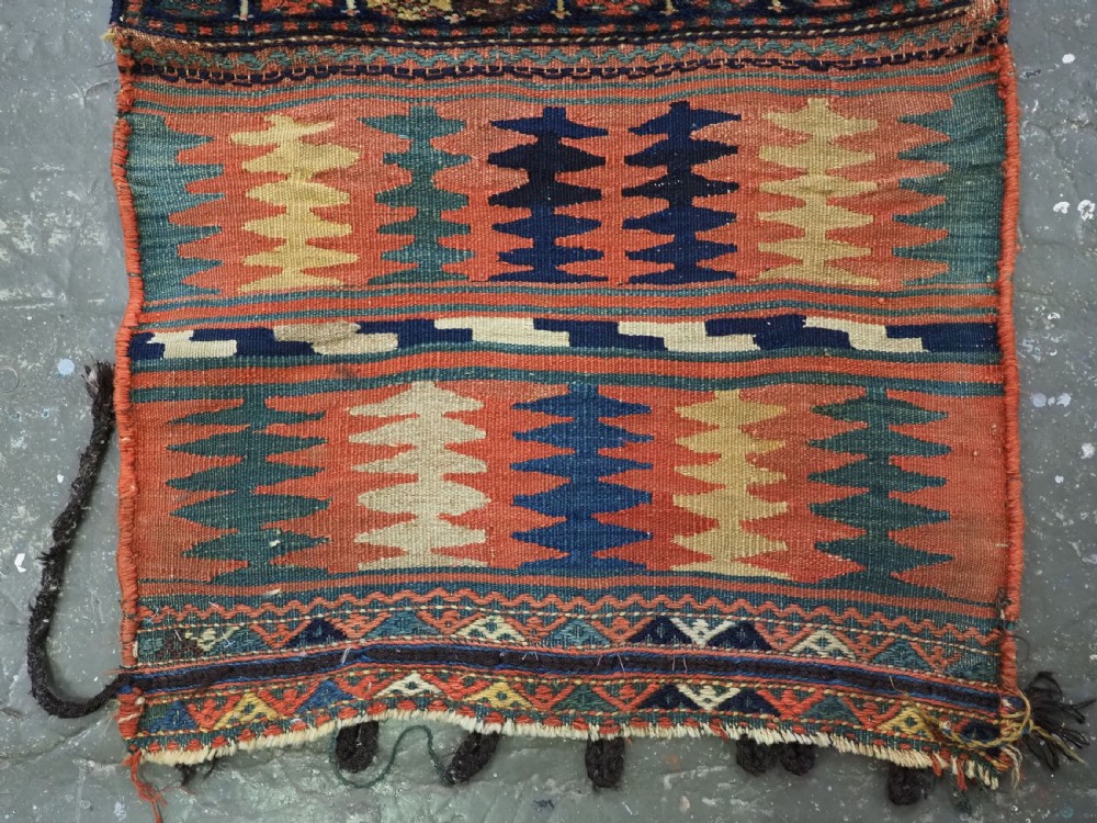 An antique 19th-century Jaf Kurd woven bag featuring a knotted pile upper panel with geometric diamond lattice motifs and a colourful flatweave back section. View IV