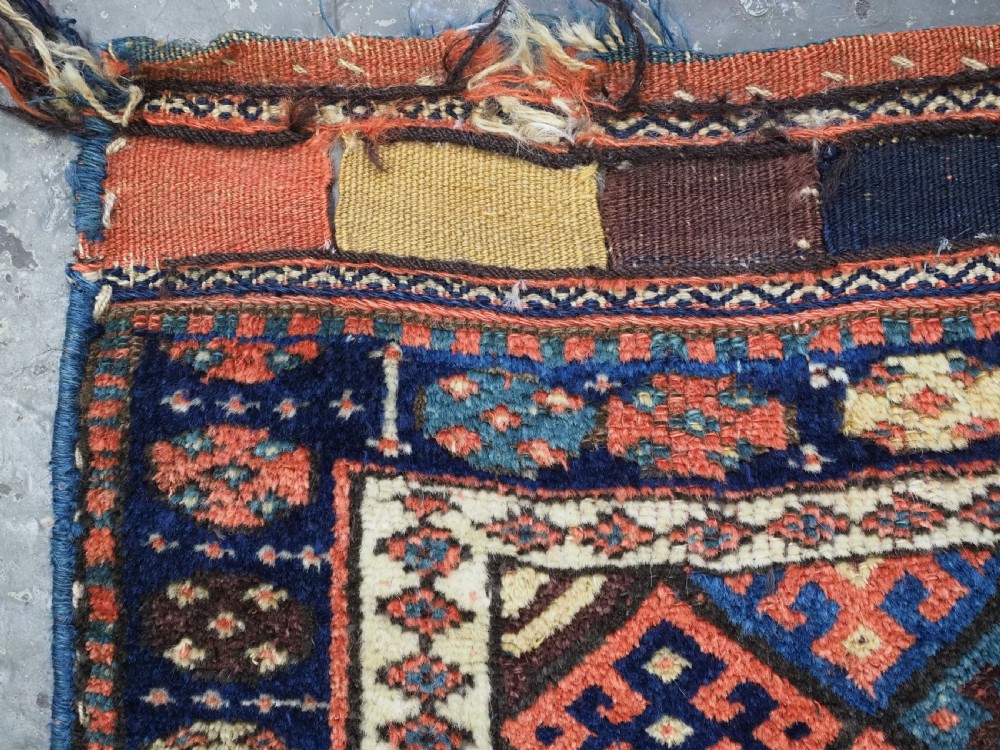 An antique 19th-century Jaf Kurd woven bag featuring a knotted pile upper panel with geometric diamond lattice motifs and a colourful flatweave back section. View V