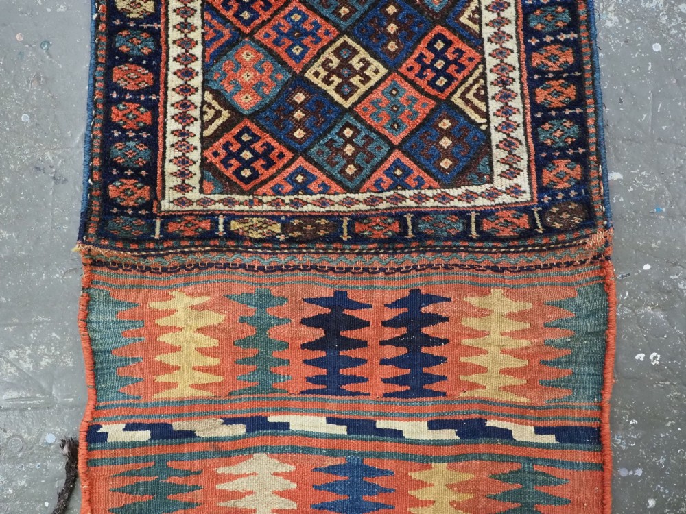 An antique 19th-century Jaf Kurd woven bag featuring a knotted pile upper panel with geometric diamond lattice motifs and a colourful flatweave back section. View VI