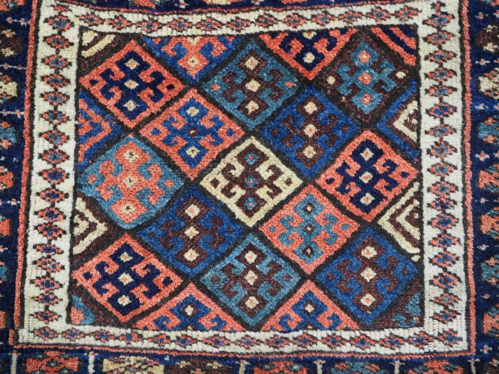 An antique 19th-century Jaf Kurd woven bag featuring a knotted pile upper panel with geometric diamond lattice motifs and a colourful flatweave back section. View VII