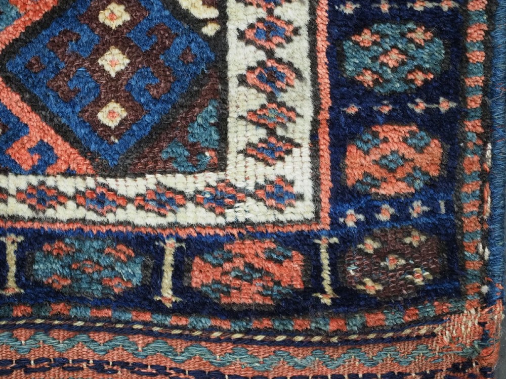 An antique 19th-century Jaf Kurd woven bag featuring a knotted pile upper panel with geometric diamond lattice motifs and a colourful flatweave back section. View IX