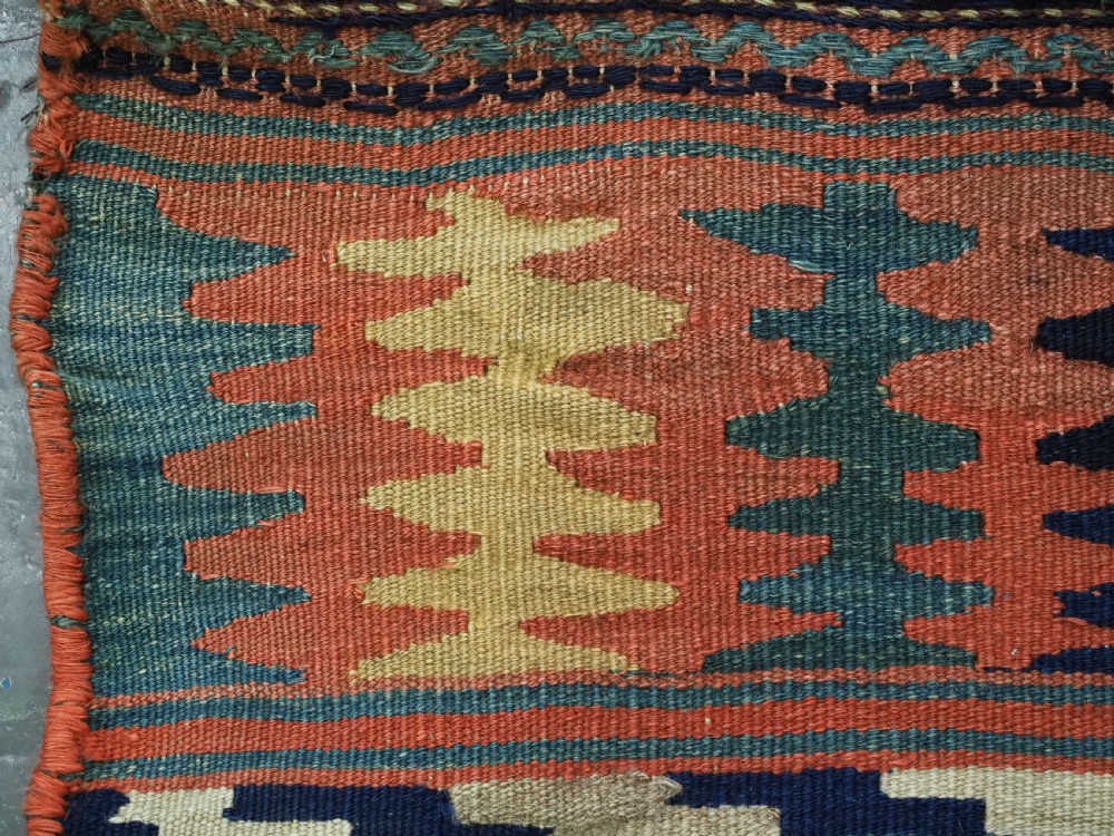 An antique 19th-century Jaf Kurd woven bag featuring a knotted pile upper panel with geometric diamond lattice motifs and a colourful flatweave back section. View X