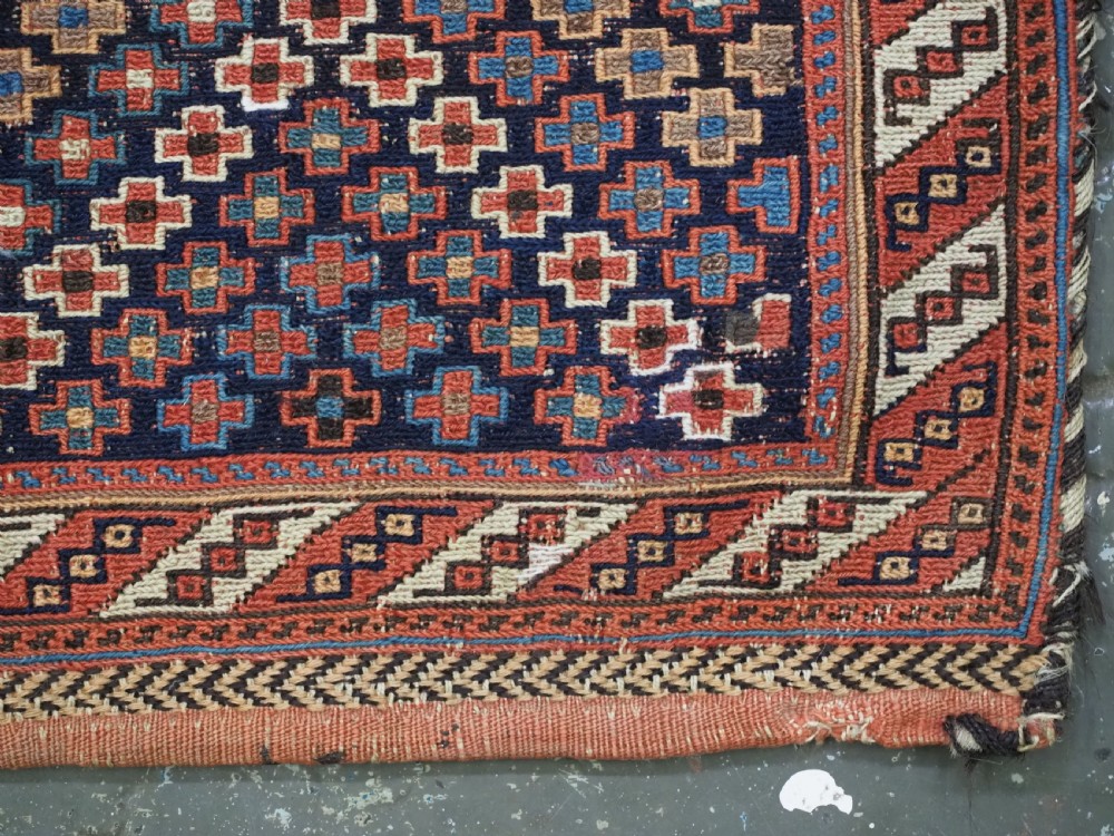 An antique Afshar tribal salt bag featuring a bottleneck neck and wide body woven in dark blue, rust red, and white geometric Soumak patterns. View VIII