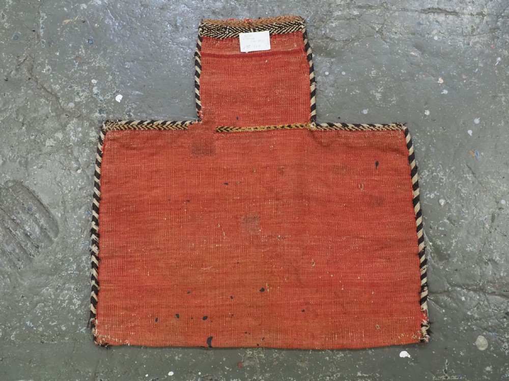 An antique Afshar tribal salt bag featuring a bottleneck neck and wide body woven in dark blue, rust red, and white geometric Soumak patterns. View XI