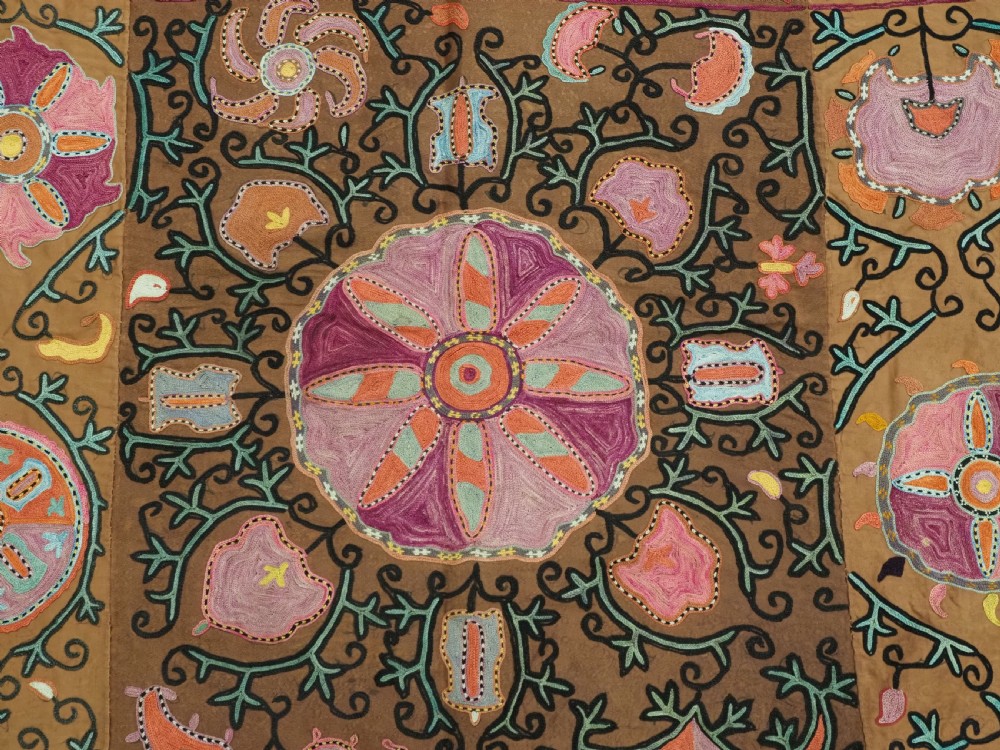 An antique Uzbek Shahrisabz region suzani textile with pink and orange silk embroidered floral medallions on a brown cotton field. View VIII