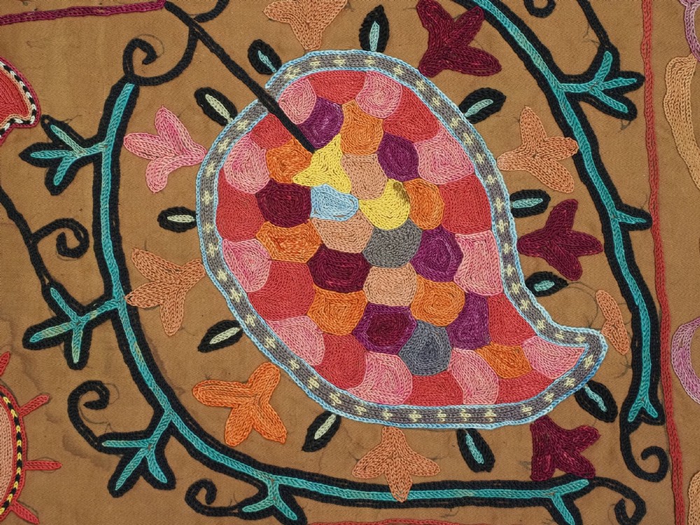 An antique Uzbek Shahrisabz region suzani textile with pink and orange silk embroidered floral medallions on a brown cotton field. View XIII