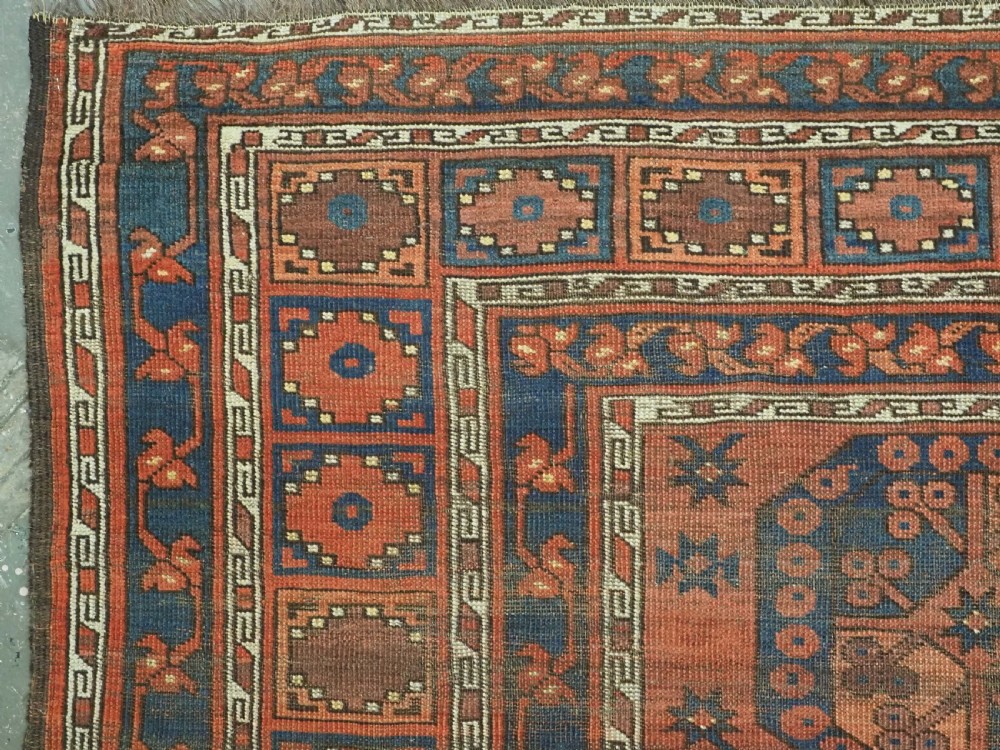 An antique Ersari Turkmen hand-knotted wool carpet displaying repeated octagonal gol motifs on a terracotta field with geometric borders. View VI
