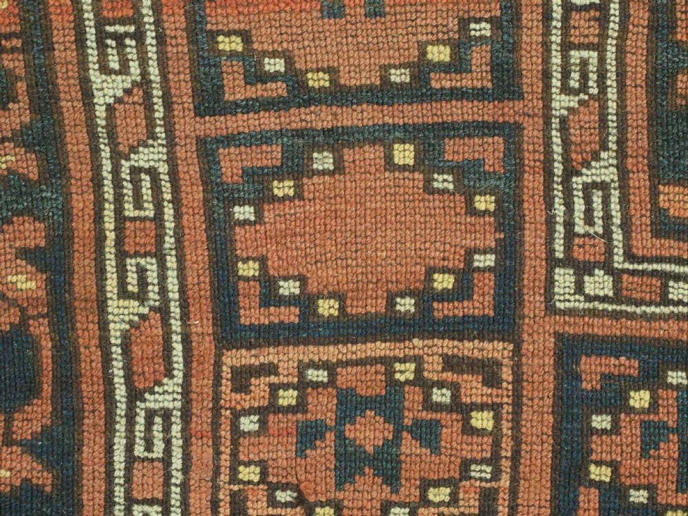 An antique Ersari Turkmen hand-knotted wool carpet displaying repeated octagonal gol motifs on a terracotta field with geometric borders. View XIII