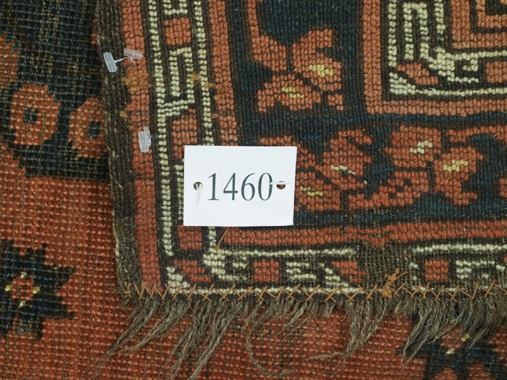 An antique Ersari Turkmen hand-knotted wool carpet displaying repeated octagonal gol motifs on a terracotta field with geometric borders. View XIV