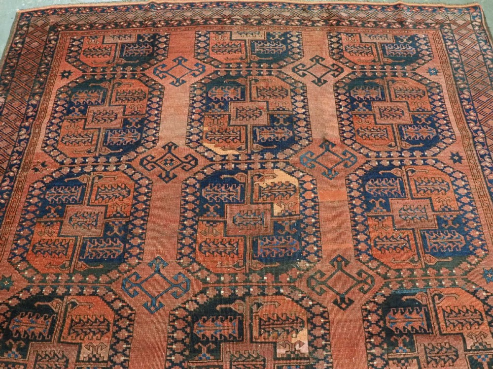A hand-knotted antique Afghan Ersari Turkmen wool carpet featuring octagonal gul motifs on a rust red ground with geometric borders. View III