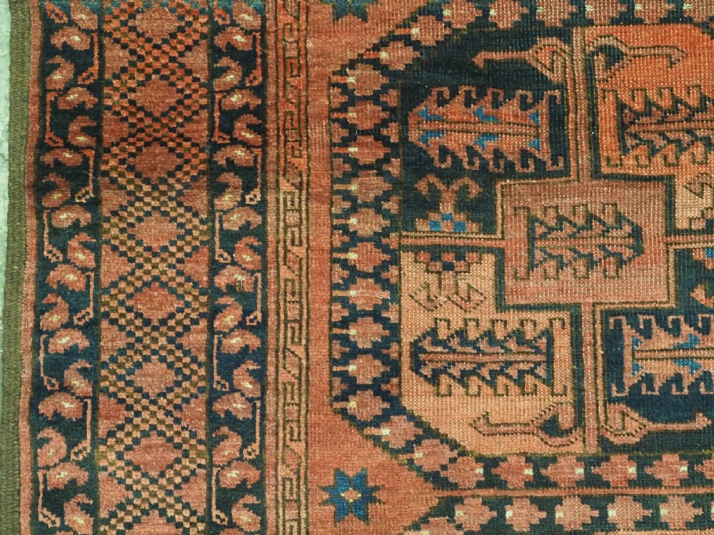 A hand-knotted antique Afghan Ersari Turkmen wool carpet featuring octagonal gul motifs on a rust red ground with geometric borders. View VI