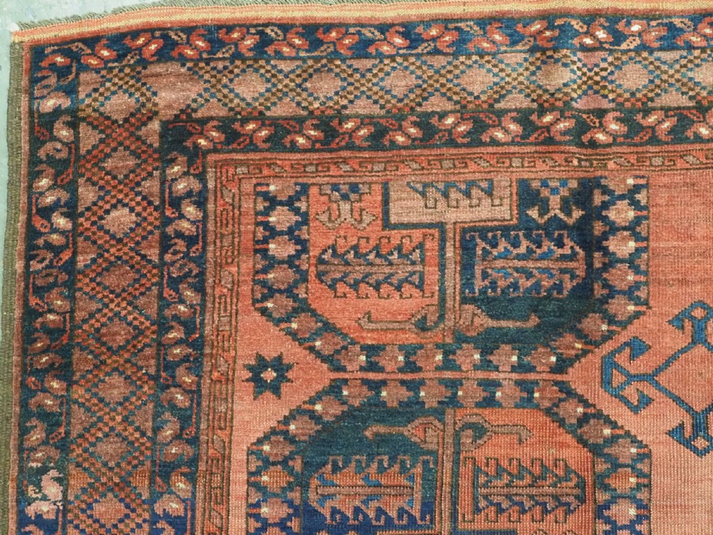 A hand-knotted antique Afghan Ersari Turkmen wool carpet featuring octagonal gul motifs on a rust red ground with geometric borders. View VII