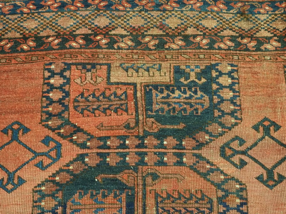 A hand-knotted antique Afghan Ersari Turkmen wool carpet featuring octagonal gul motifs on a rust red ground with geometric borders. View VIII