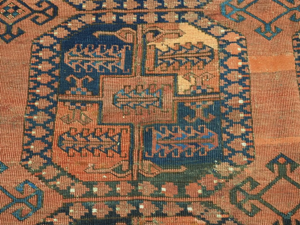 A hand-knotted antique Afghan Ersari Turkmen wool carpet featuring octagonal gul motifs on a rust red ground with geometric borders. View IX