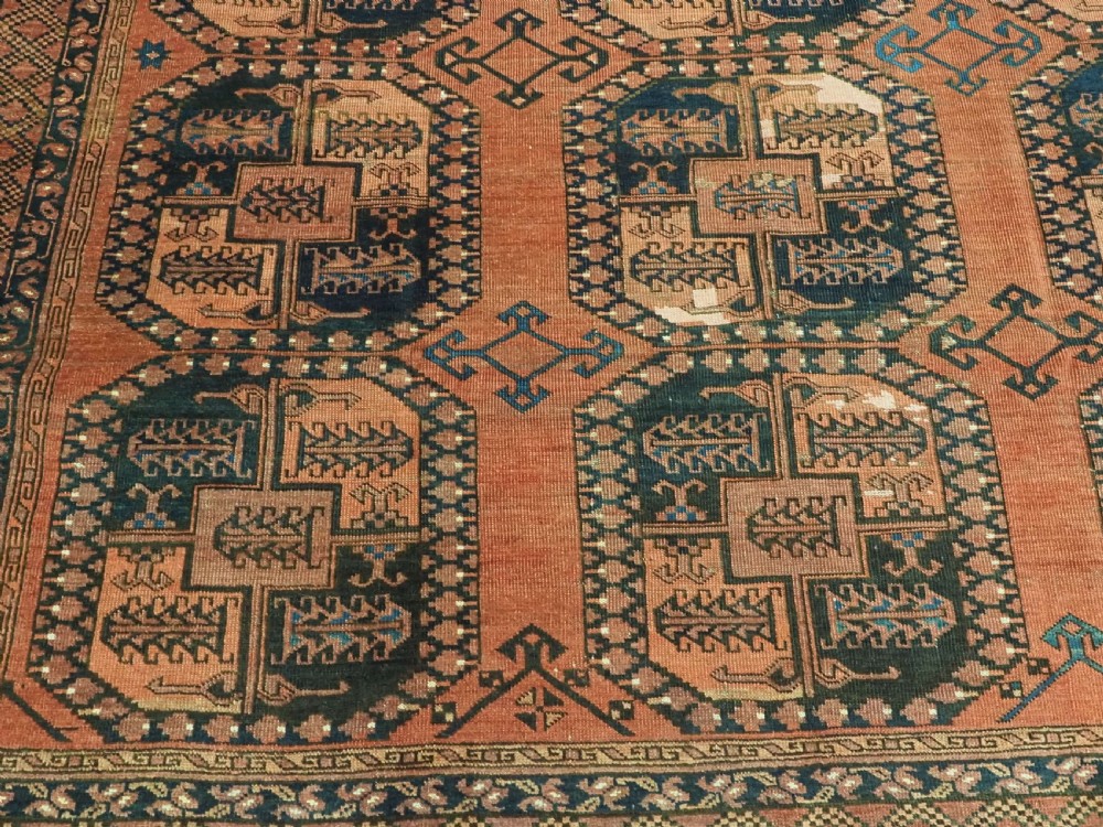 A hand-knotted antique Afghan Ersari Turkmen wool carpet featuring octagonal gul motifs on a rust red ground with geometric borders. View XI