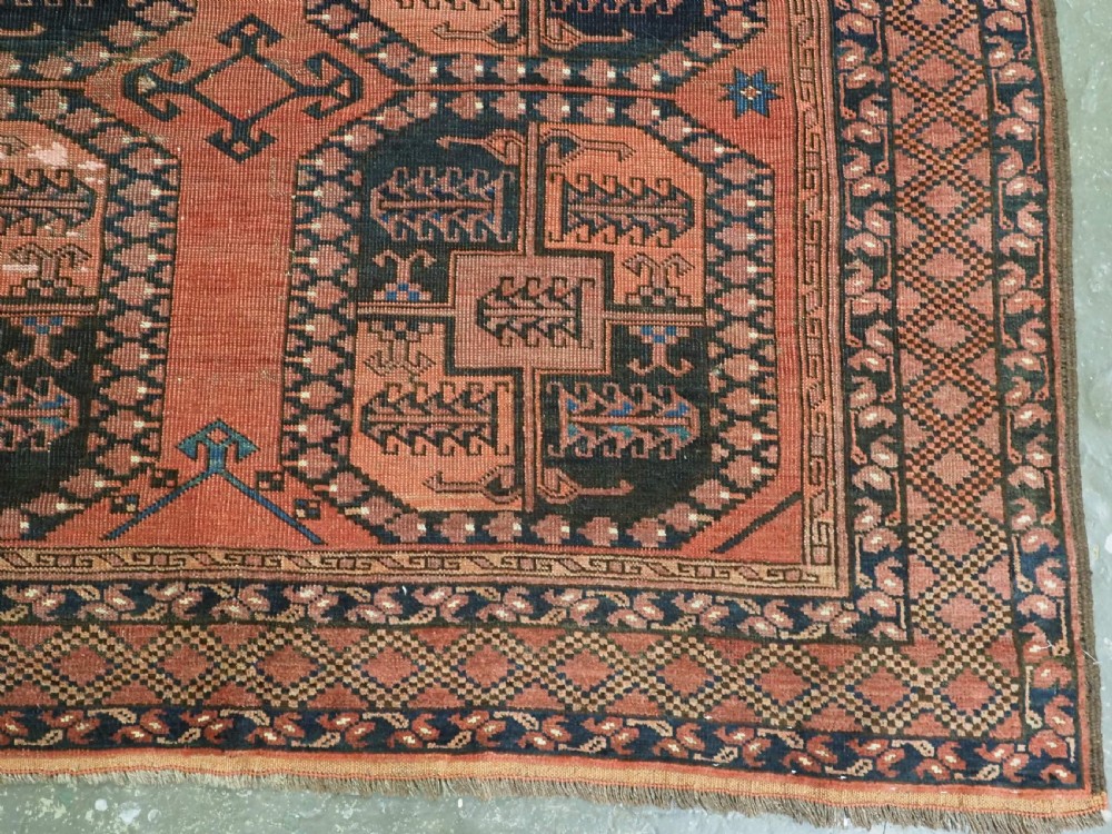 A hand-knotted antique Afghan Ersari Turkmen wool carpet featuring octagonal gul motifs on a rust red ground with geometric borders. View XII