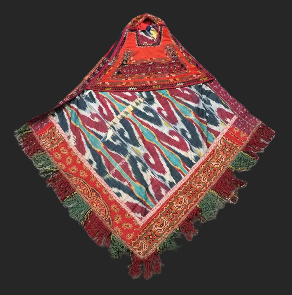 A RARE UZBEK KARAKALPAK LADIES EMBROIDERED WEDDING VEIL WITH SILK IKAT BACK, 19TH CENTURY.