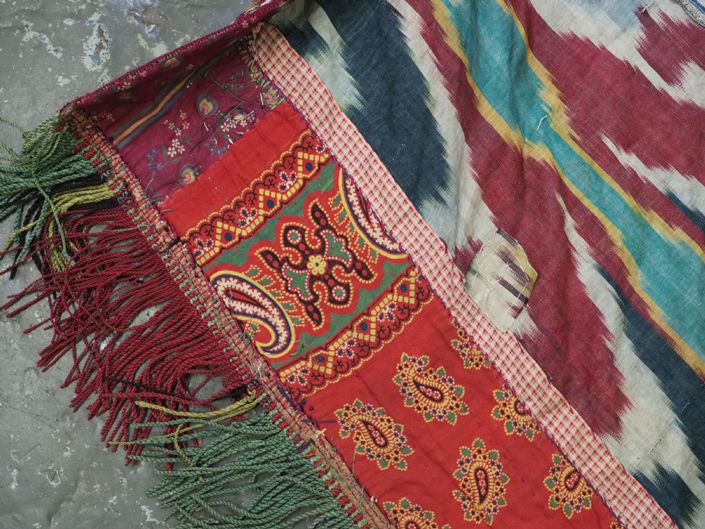 A RARE UZBEK KARAKALPAK LADIES EMBROIDERED WEDDING VEIL WITH SILK IKAT BACK, 19TH CENTURY. View IX