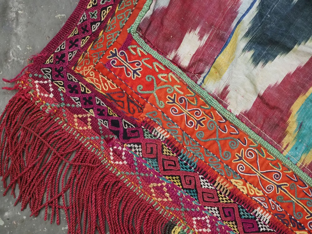 A RARE UZBEK KARAKALPAK LADIES EMBROIDERED WEDDING VEIL WITH SILK IKAT BACK, 19TH CENTURY. View XVI