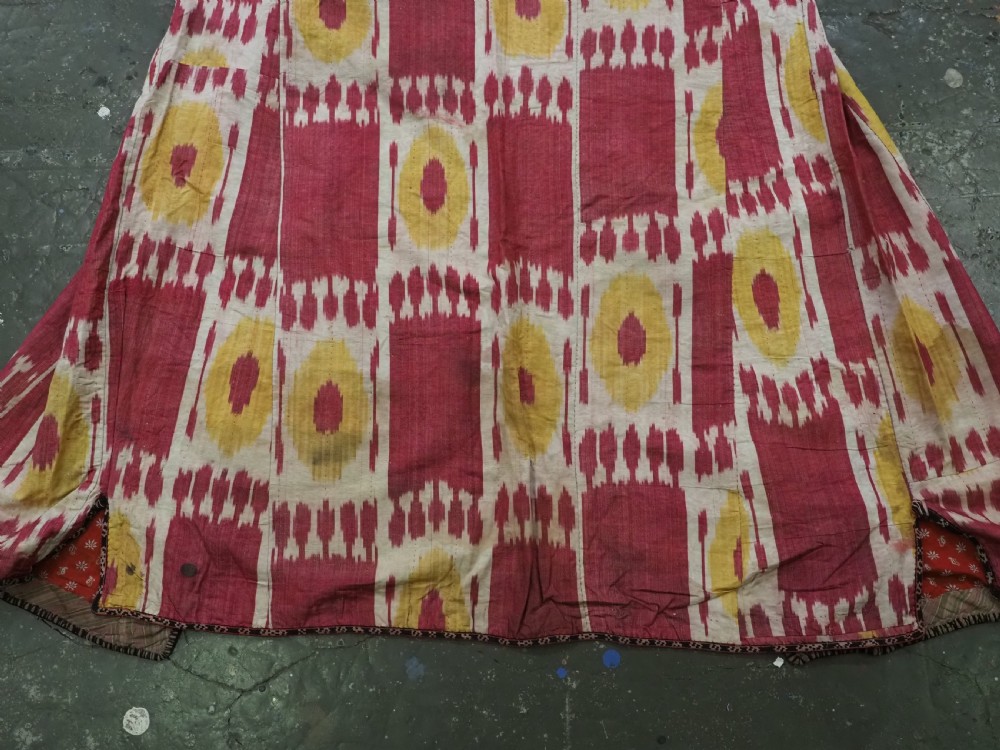 An antique T-shaped Uzbek silk ikat robe featuring geometric motifs in magenta, yellow, and off-white. View VI