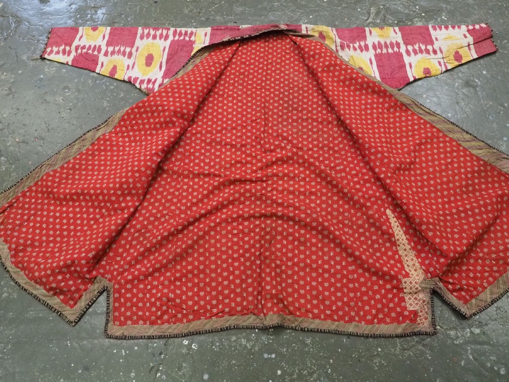An antique T-shaped Uzbek silk ikat robe featuring geometric motifs in magenta, yellow, and off-white. View XIII