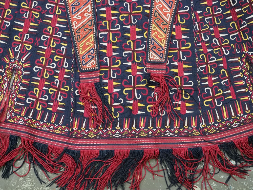 An antique 19th-century Turkmen chyrpy ceremonial coat featuring dense red, yellow, and white silk hand embroidery on a dark base with fringed borders. View VI