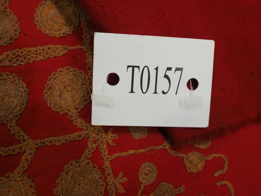 A rectangular red wool shawl with extensive gold-coloured needlework along the borders and corner motifs. View XVII